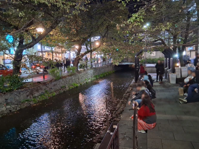 Kyoto, people relaxing at night near Pontocho Alley